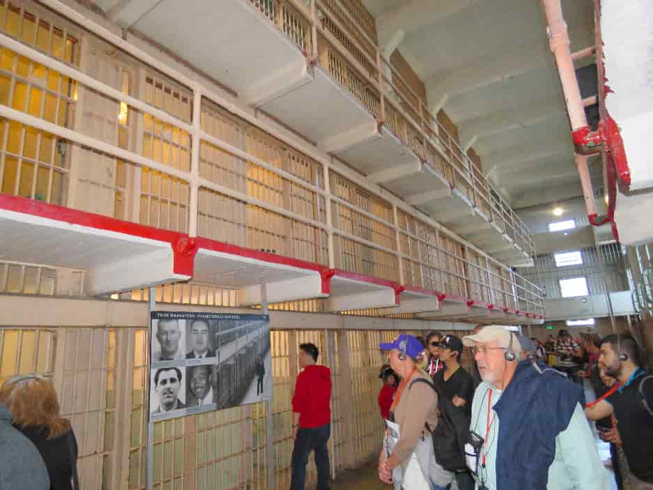 visitors-walking-tour-inside-Alcatraz-Penitentiary-cell-block-min-